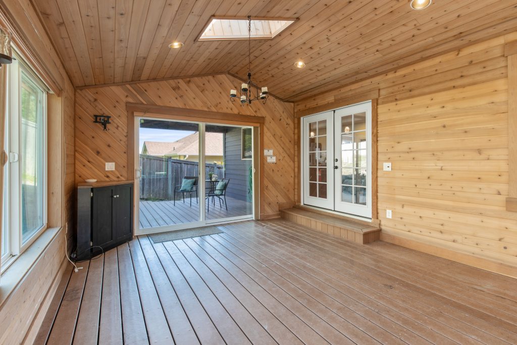 These sliders lead out to a covered deck with recessed lighting and a skylight. 