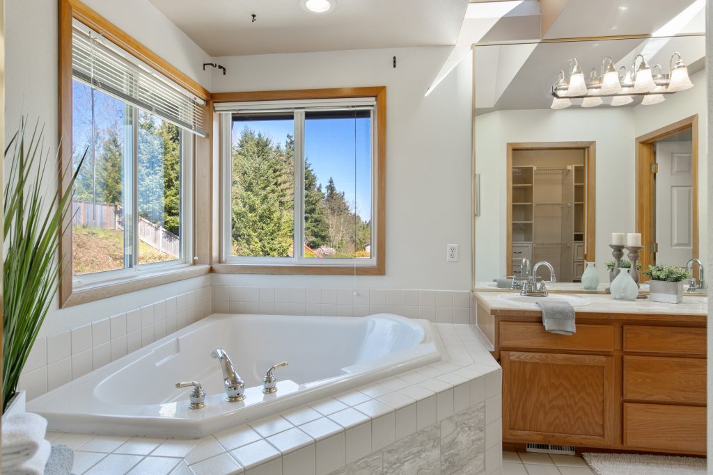 The master bath boasts a walk-in shower and a soaking tub with a beautiful marble inset. 