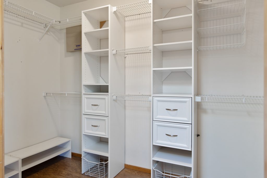 The spacious master walk-in closet features built-in organizers. 