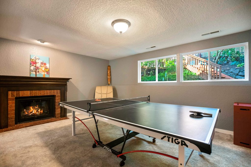 The lower level features a spacious family room, perfect for playing games and hanging out. It also has a wood-burning fireplace.