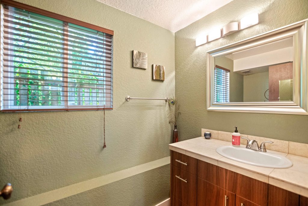 There is an updated half bath on the lower level that also has marble countertops and a walnut vanity.