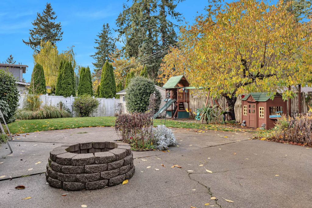 Notice the extensive entertaining patio with firepit and the charming play area. There are two sheds that stay as well.