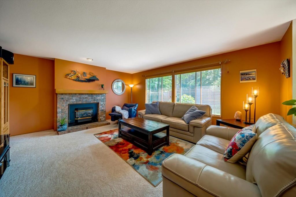 The family room boasts a gas fireplace and huge picture windows that frame the gorgeous back yard.