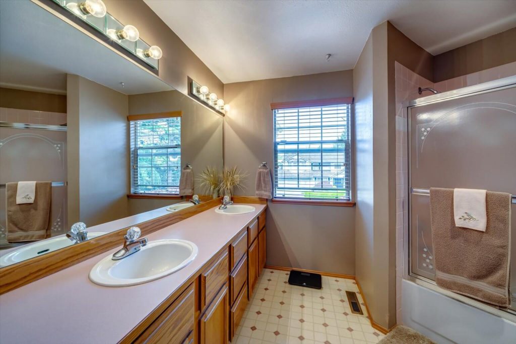 The hall bath upstairs features dual vanities and a shower/tub combination.