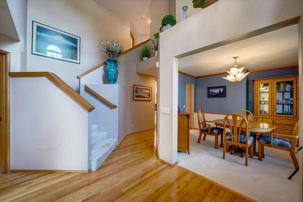 Step into the foyer with soaring ceilings and gleaming hardwoods.